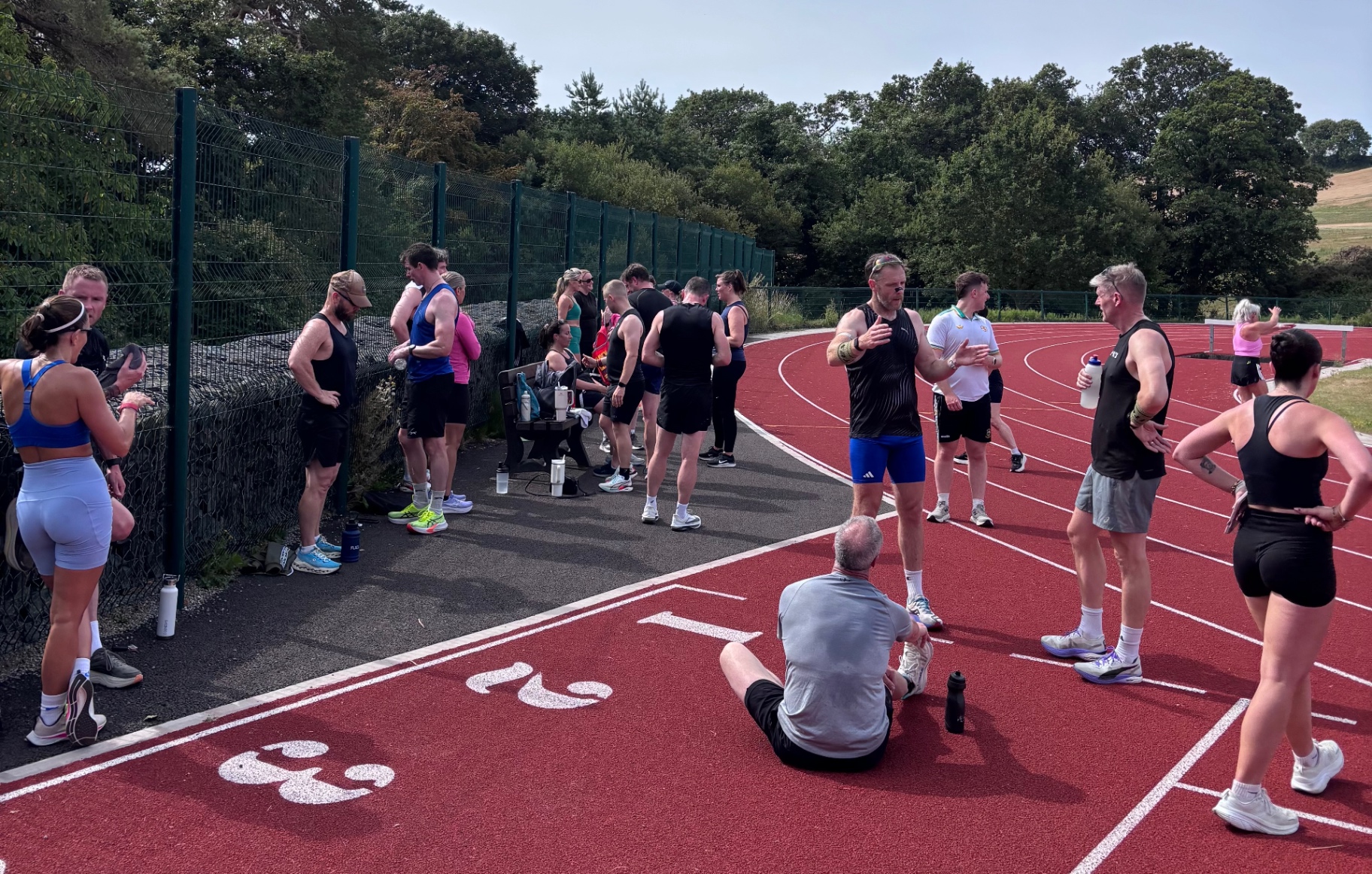 Hevo coach cueing a member's form during a class
